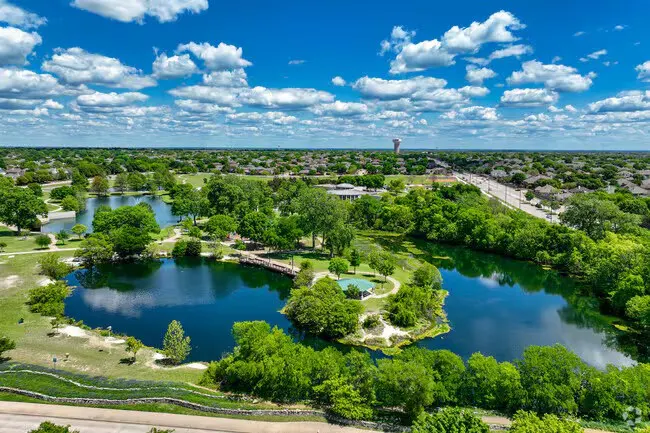 Ponds and parkland in Allen with the water tower on the horizon