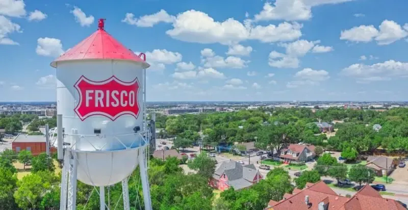 The red and white Frisco water tower over the old town