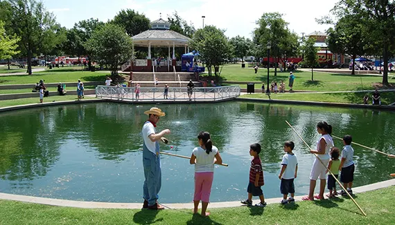 Families fishing at the Haggard Park pond in downtown Plano